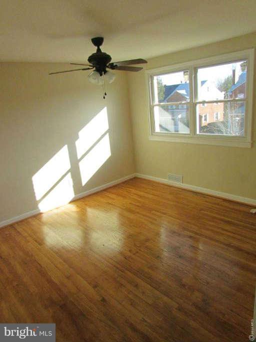 1808 Burnwood Road Baltimore, MD 21239 - Photo 17 of 25 a view of empty room with wooden floor and fan