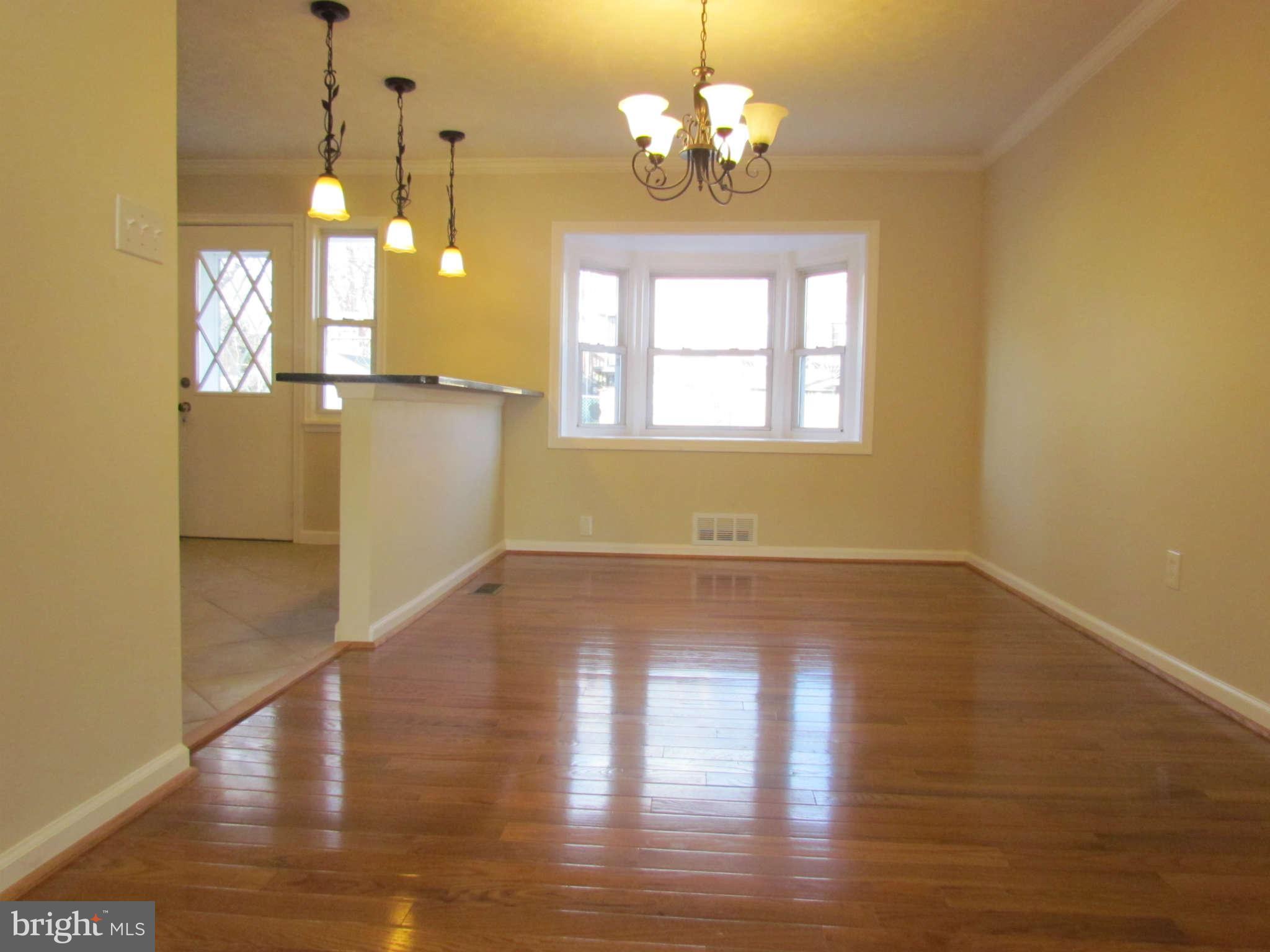 1808 Burnwood Road Baltimore, MD 21239 - Photo 20 of 25 a view of a room with wooden floor and chandelier