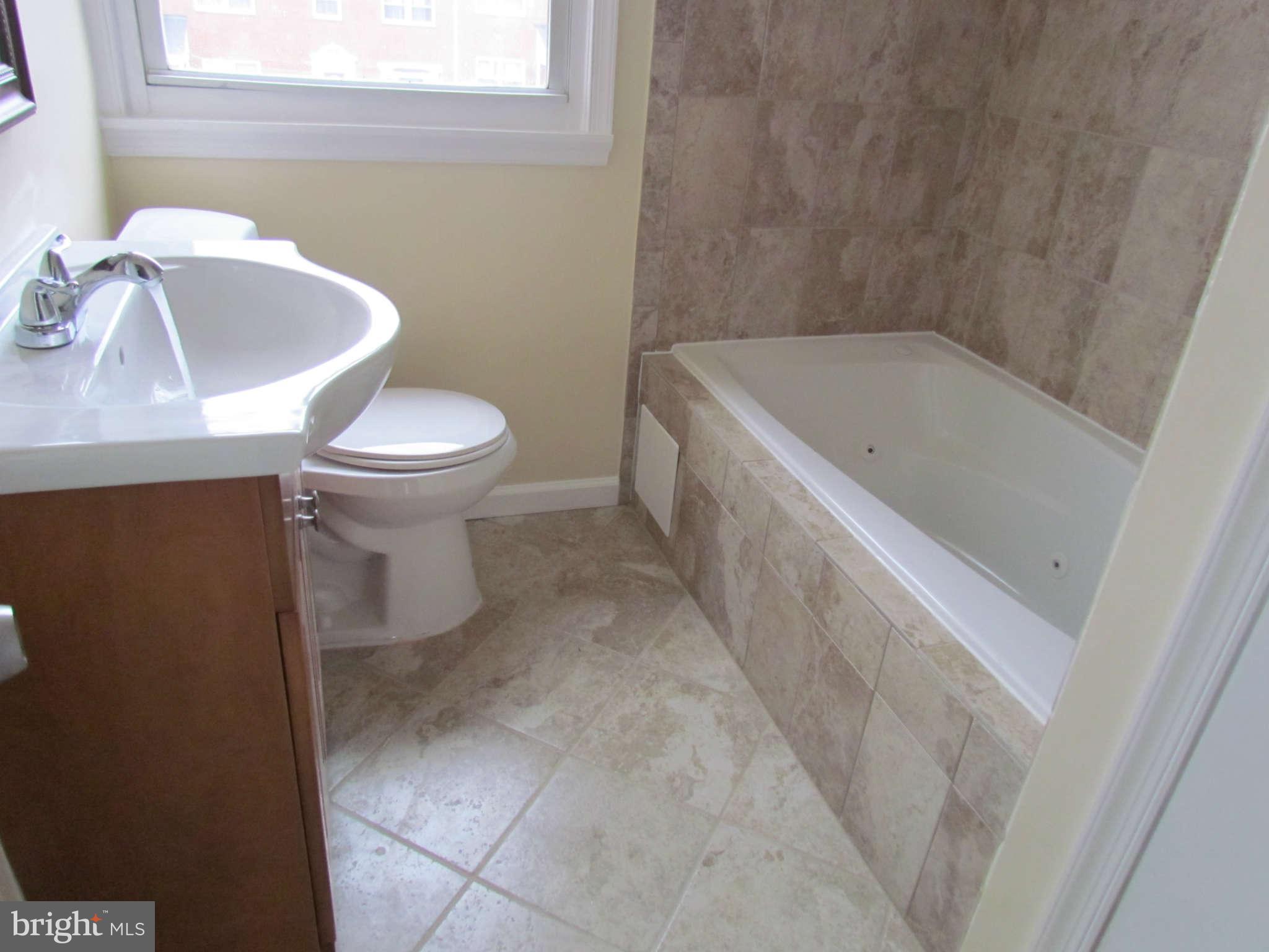1808 Burnwood Road Baltimore, MD 21239 - Photo 24 of 25 a bathroom with a sink and a bathtub