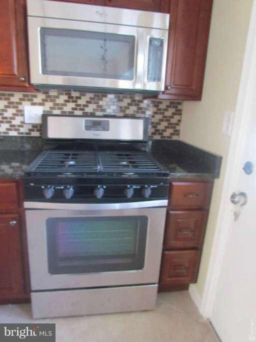 1808 Burnwood Road Baltimore, MD 21239 - Photo 5 of 25 a stove top oven sitting inside of a kitchen