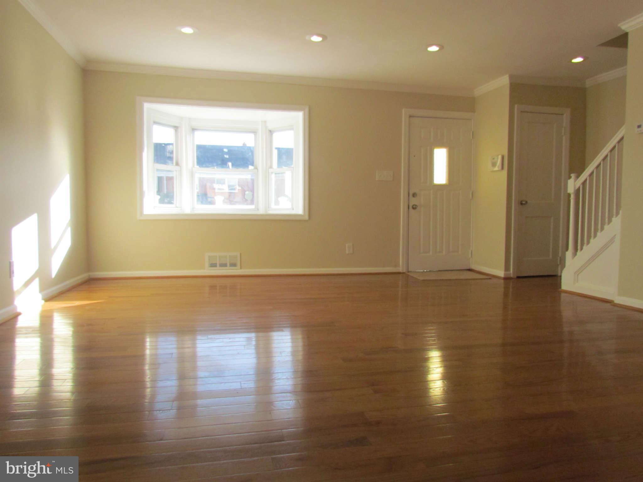 1808 Burnwood Road Baltimore, MD 21239 - Photo 8 of 25 a view of empty room with wooden floor and fan