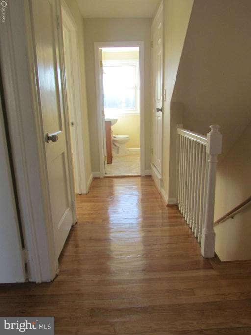 1808 Burnwood Road Baltimore, MD 21239 - Photo 9 of 25 a view of a hallway with wooden floor