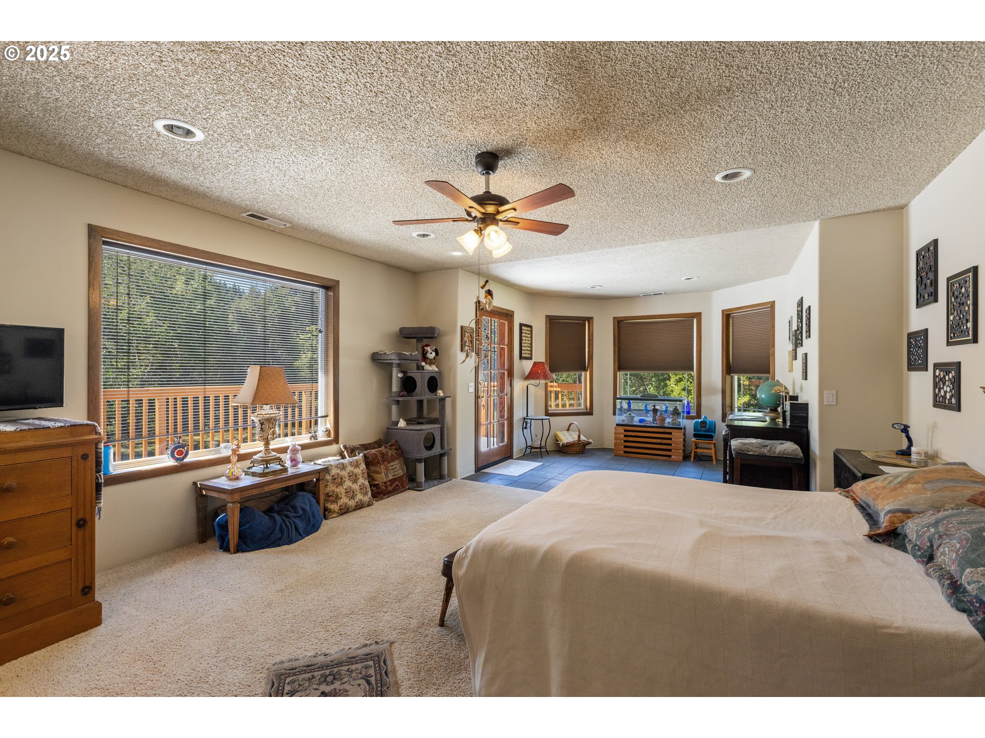 913 Starveout Creek Road Azalea, OR 97410 - Photo 15 of 27 a bedroom with a bed a large window and furniture