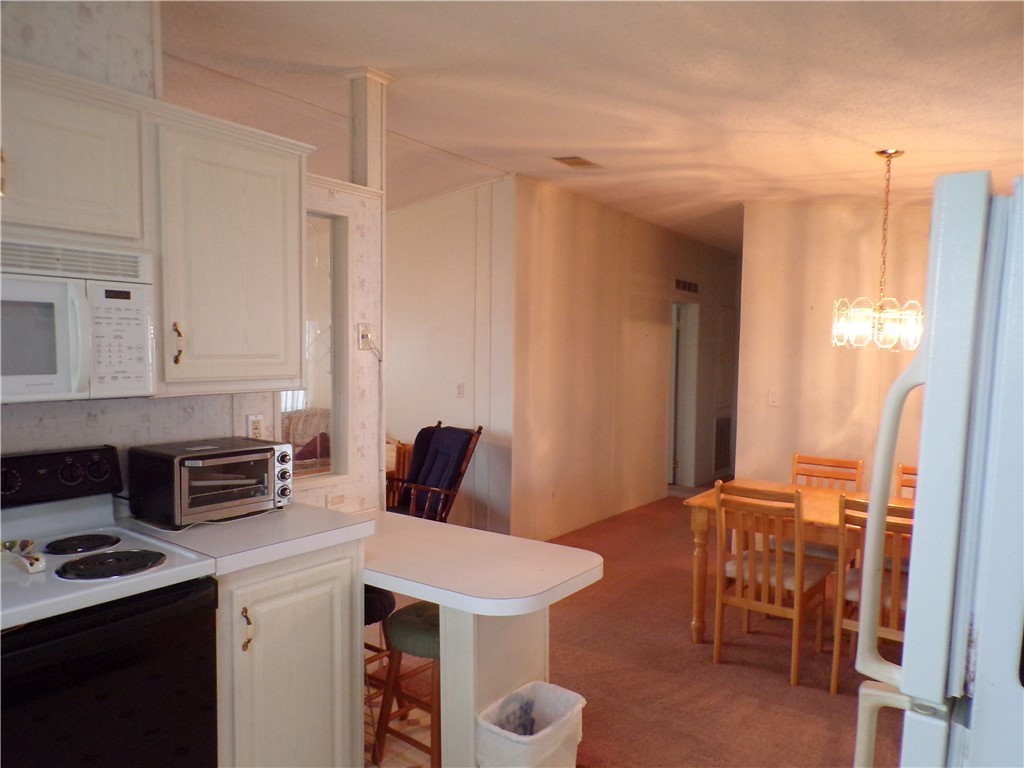 941 Wren Circle Sebastian, FL 32976 - Photo 2 of 16 a kitchen that has a table and chairs in it