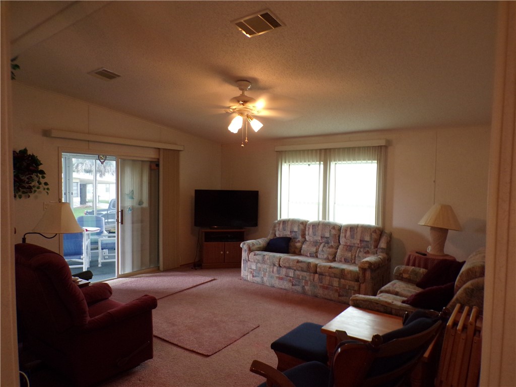 941 Wren Circle Sebastian, FL 32976 - Photo 5 of 16 a living room with furniture and a flat screen tv