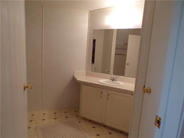 a bathroom with a sink and mirror