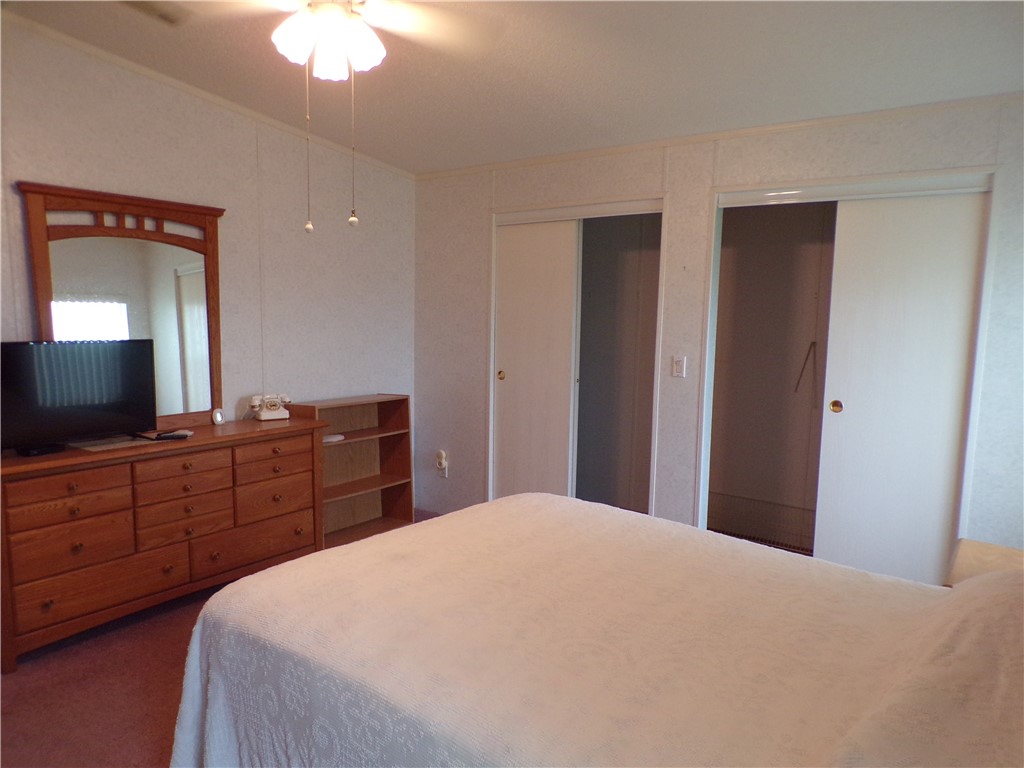 941 Wren Circle Sebastian, FL 32976 - Photo 10 of 16 a bedroom with a bed and a flat screen tv