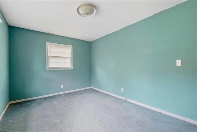 a view of empty room with wooden ceiling