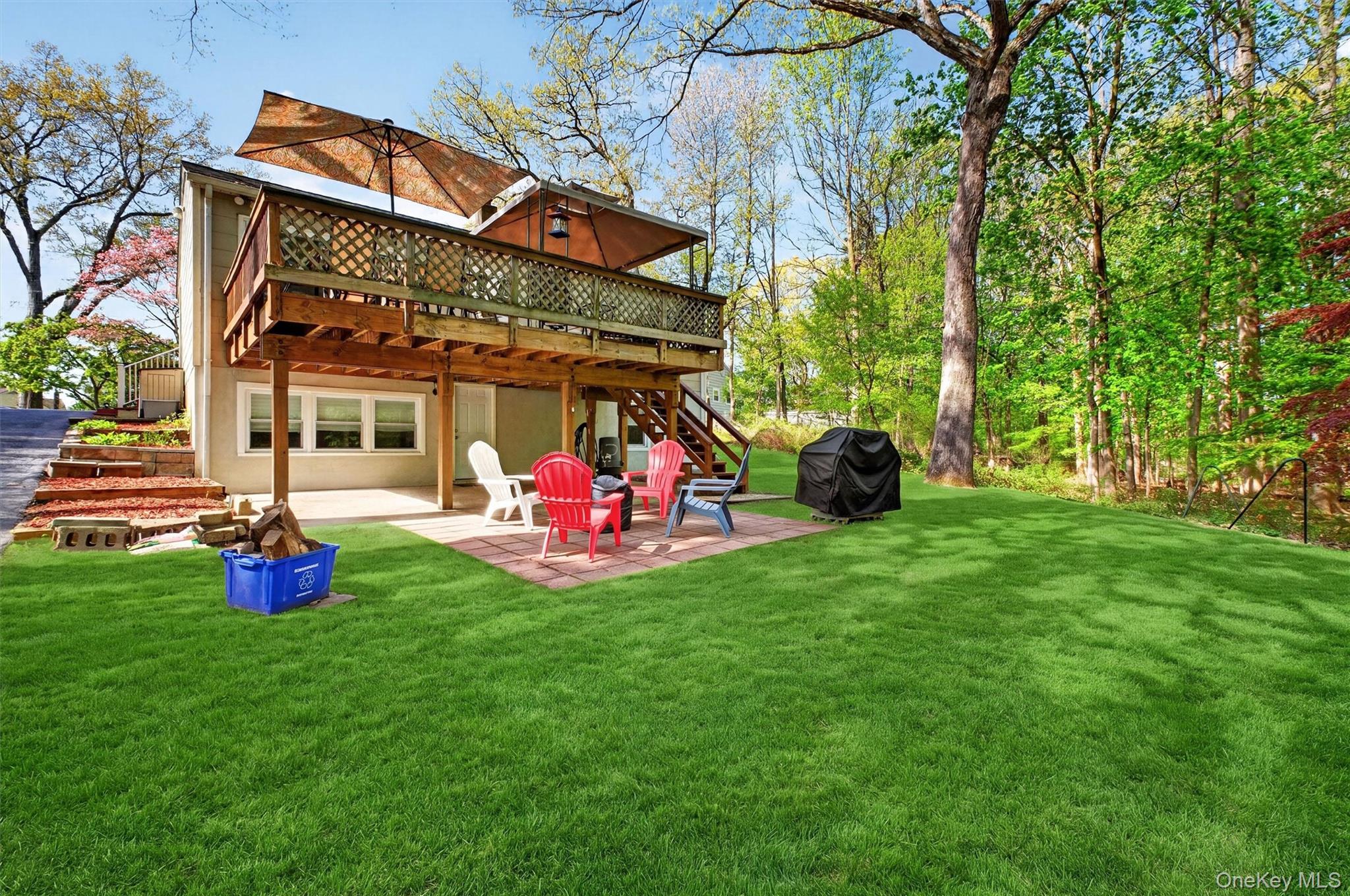 25 High Road Montrose, NY 10548 - Photo 36 of 42 Back of home shows deck, patio and yard