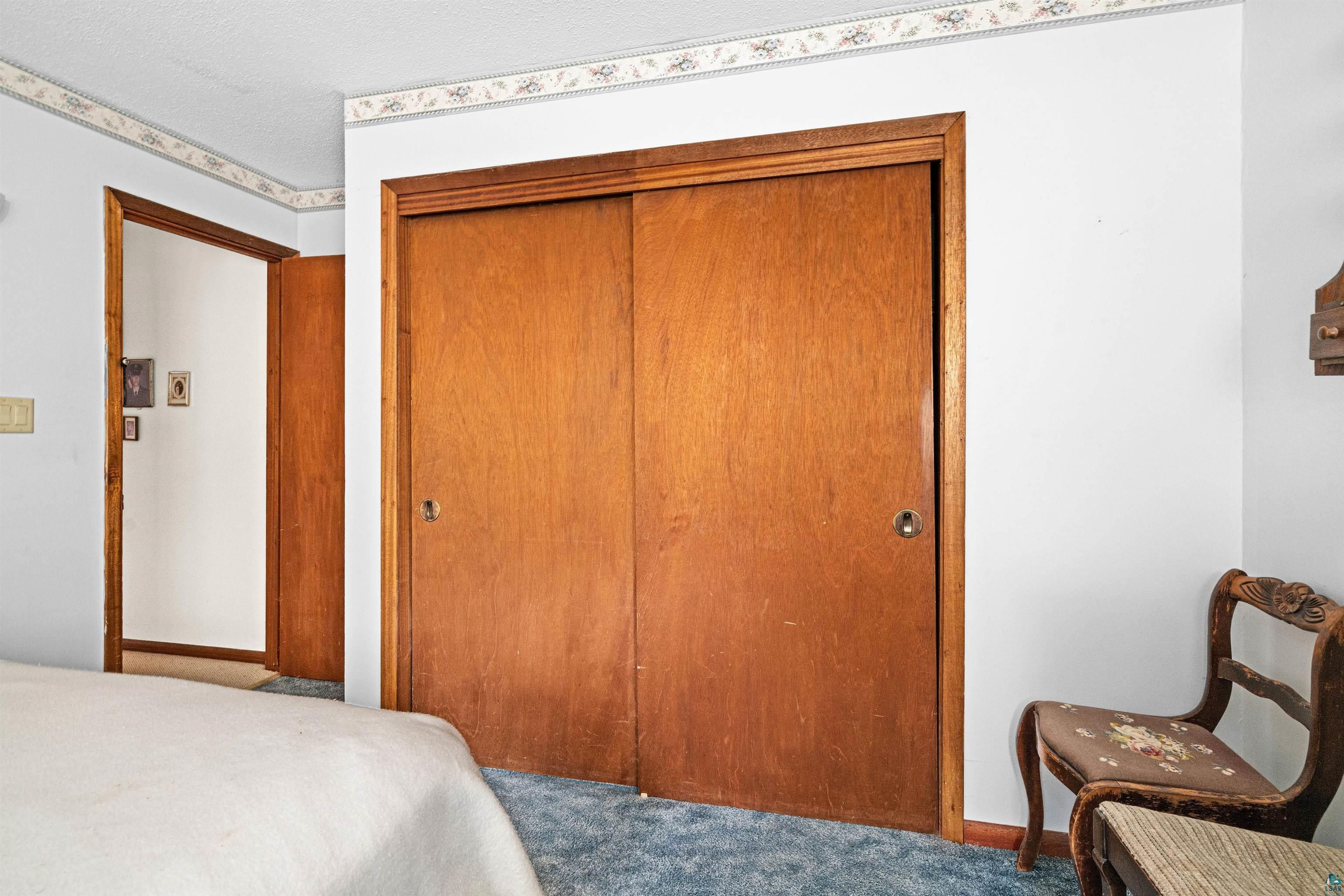 6242 State Highway 1 Silver Bay, MN 55614 - Photo 16 of 43 Bedroom featuring carpet flooring, a closet, and baseboards