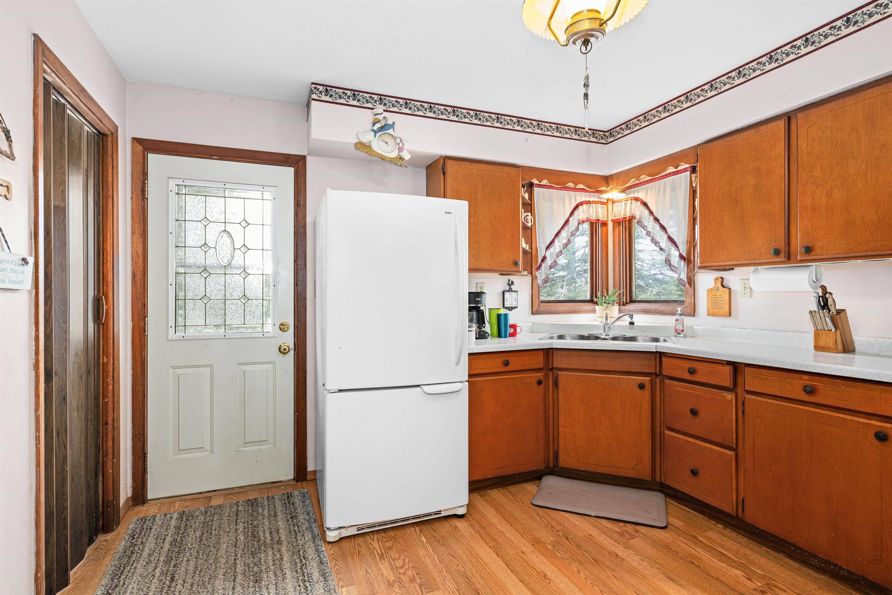 6242 State Highway 1 Silver Bay, MN 55614 - Photo 6 of 43 Kitchen with freestanding refrigerator, a sink, light countertops, and light wood-style flooring