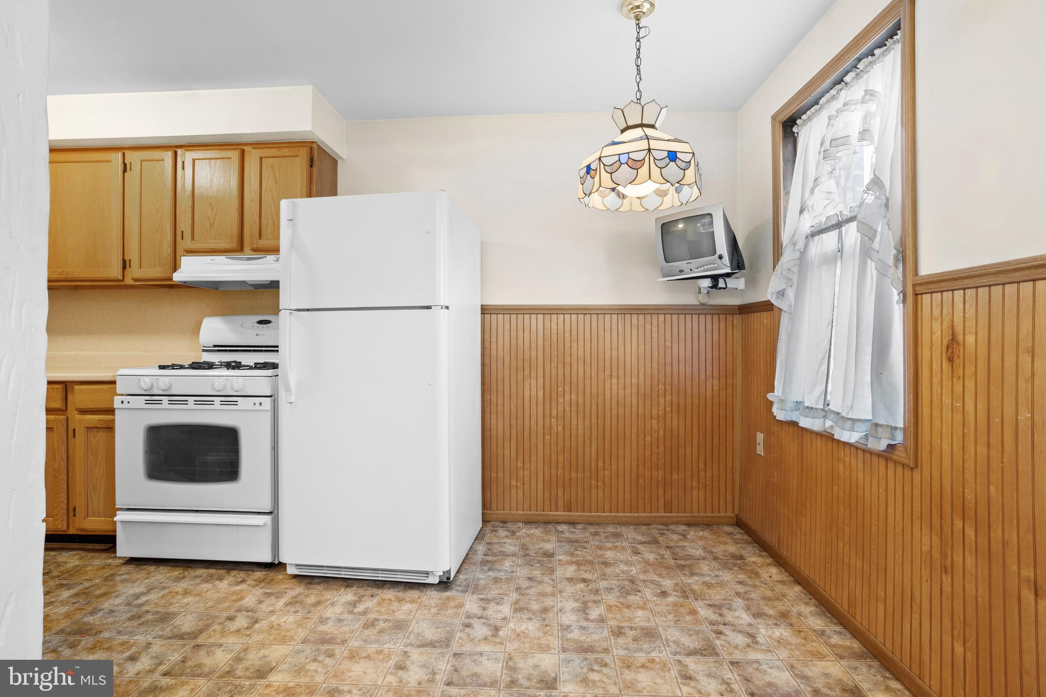969 Grant Road Folcroft, PA 19032 - Photo 8 of 20 a white refrigerator freezer sitting inside of a kitchen