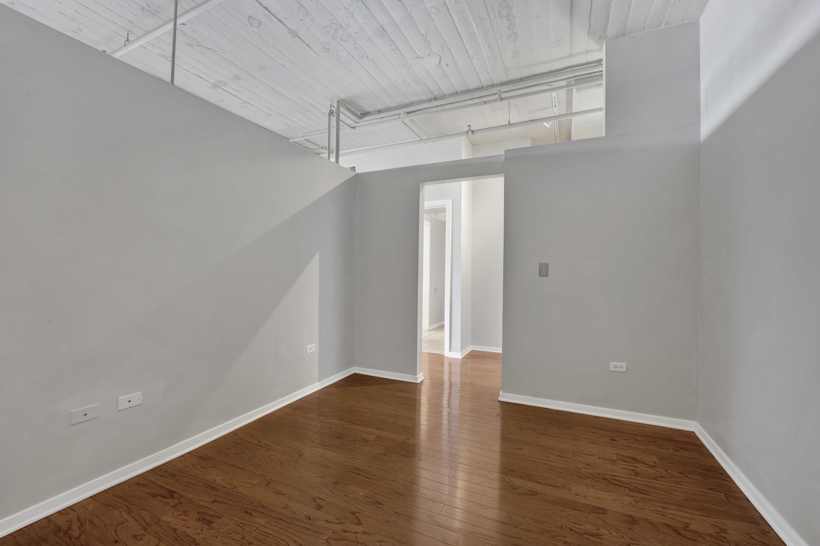 1525 South Sangamon Street, Unit 504 Chicago, IL 60608 - Photo 15 of 32 a view of an empty room with wooden floor
