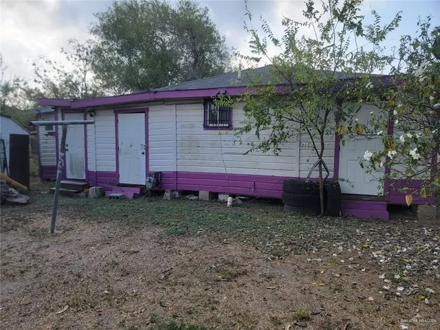 a view of a backyard with a large tree