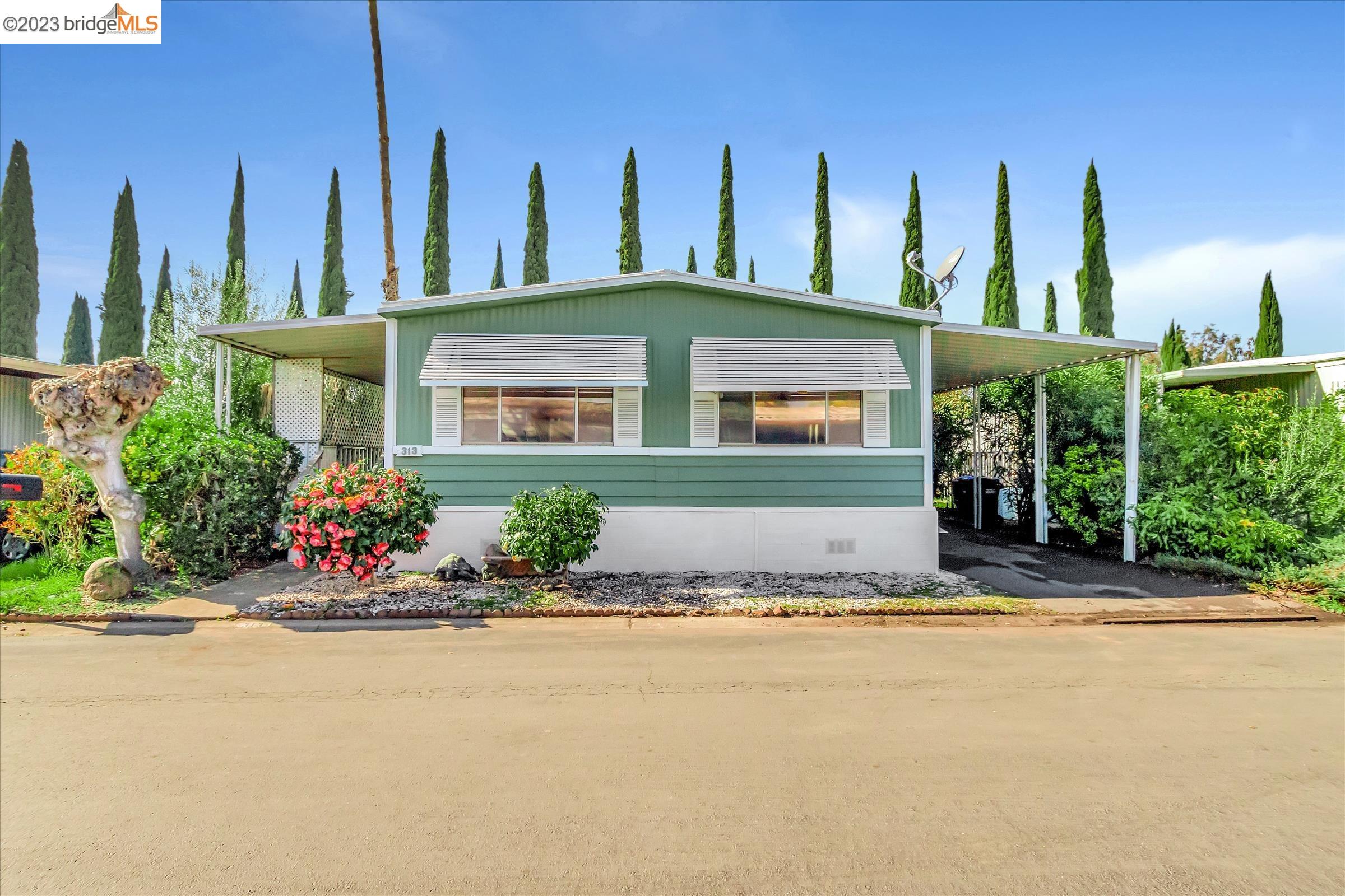 a front view of a house with a garden