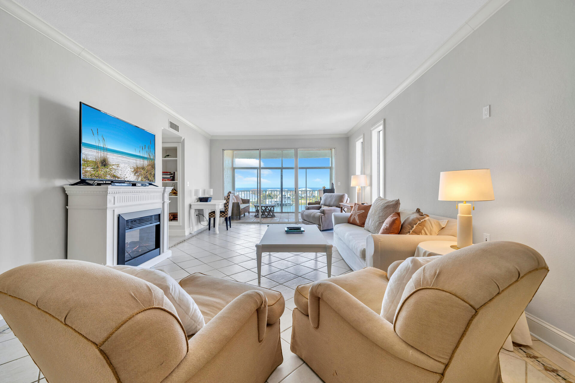 30 Moreno Point Road, Unit 704C Destin, FL 32541 - Photo 11 of 54 a living room with fireplace furniture and a flat screen tv