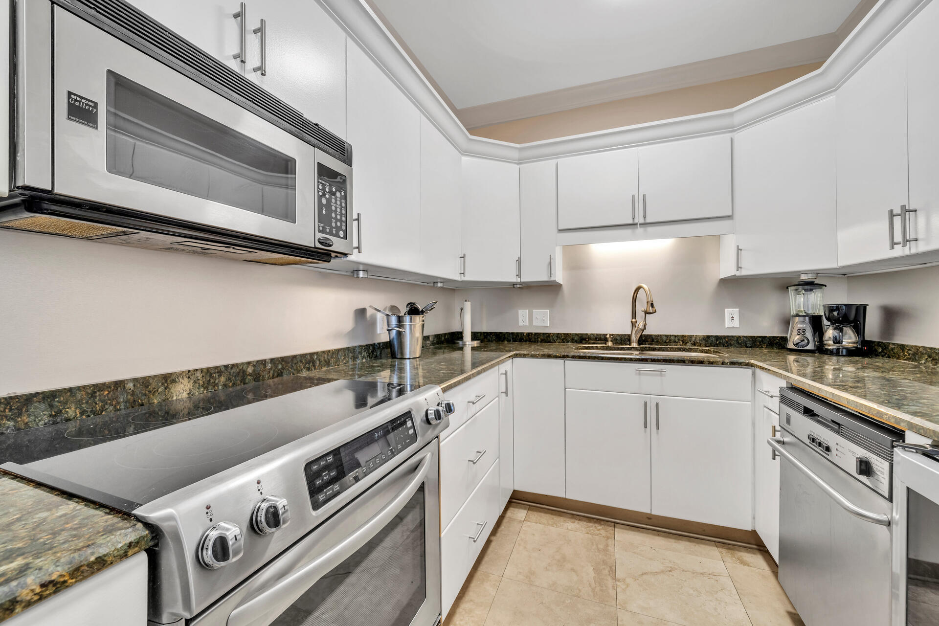 30 Moreno Point Road, Unit 704C Destin, FL 32541 - Photo 9 of 54 a kitchen with stainless steel appliances granite countertop a stove and a microwave