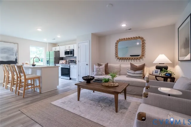 a living room with furniture and a potted plant