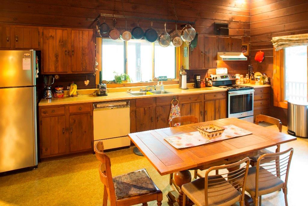 743 Cardville Road Greenbush, ME 04418 - Photo 10 of 34 Stove cookware hangs above the...
