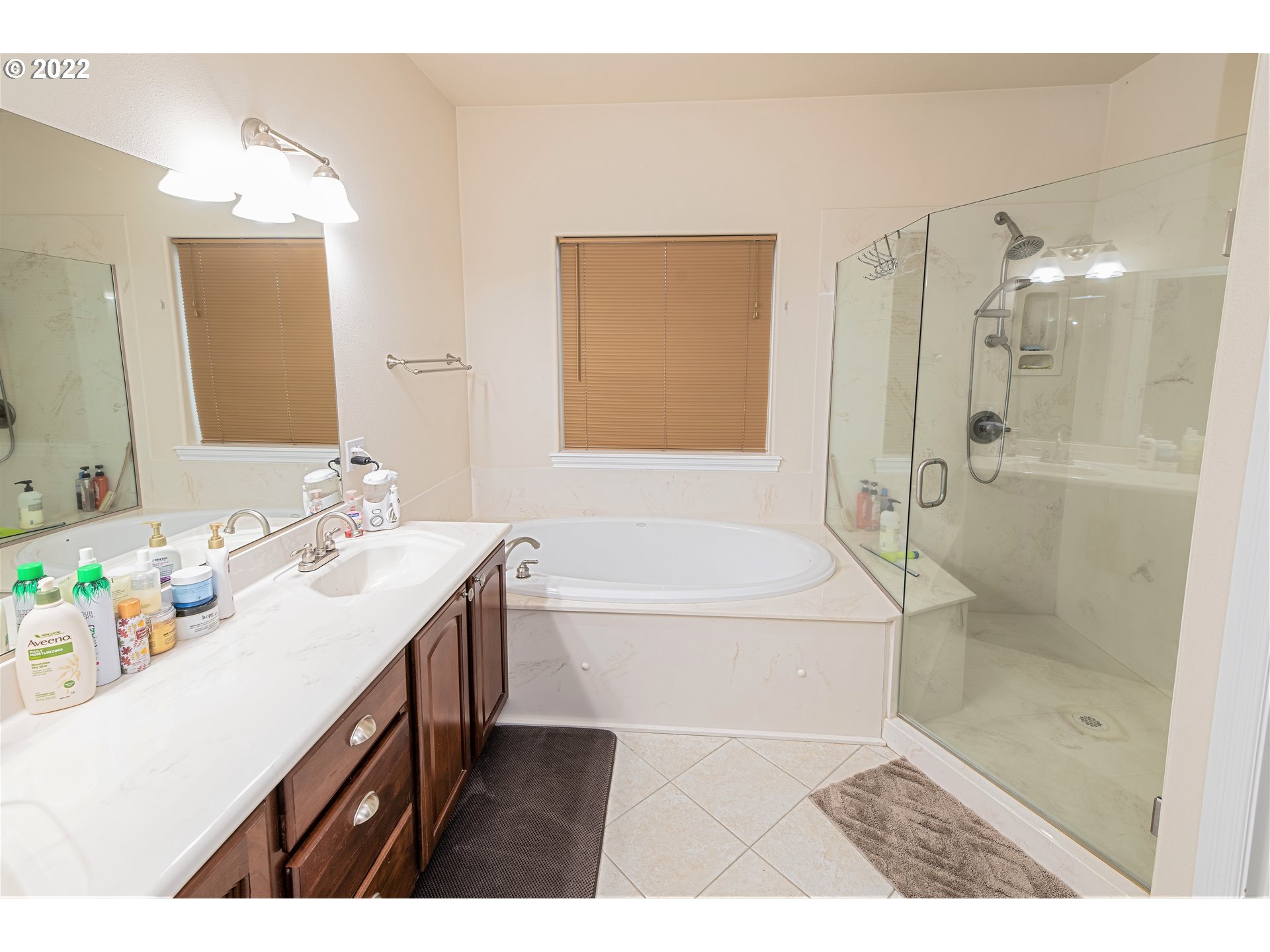235 Boyer Road Grants Pass, OR 97526 - Photo 20 of 27 a bathroom with a granite countertop sink a mirror a bathtub and shower