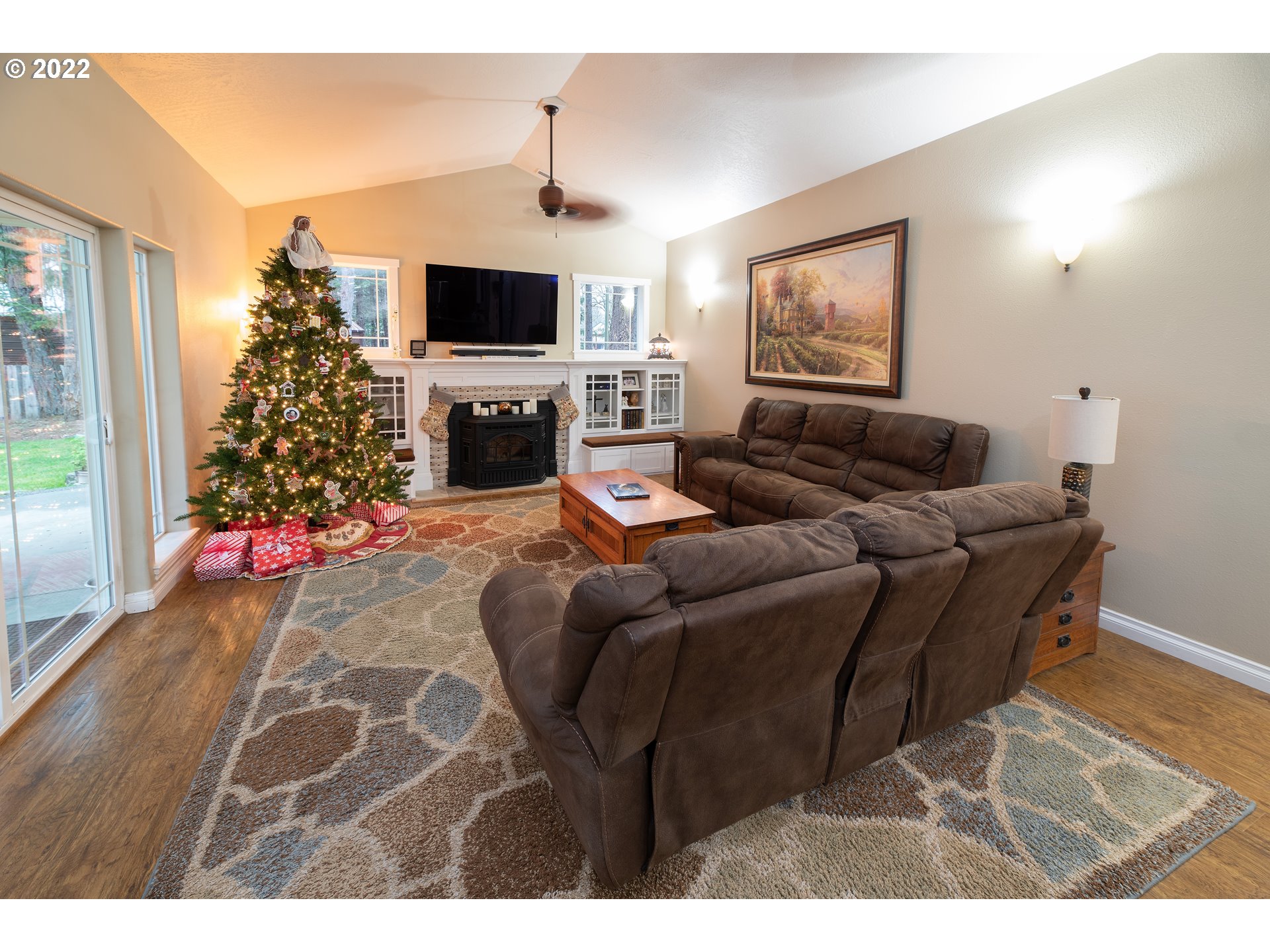 235 Boyer Road Grants Pass, OR 97526 - Photo 23 of 27 a living room with furniture a flat screen tv and a fireplace