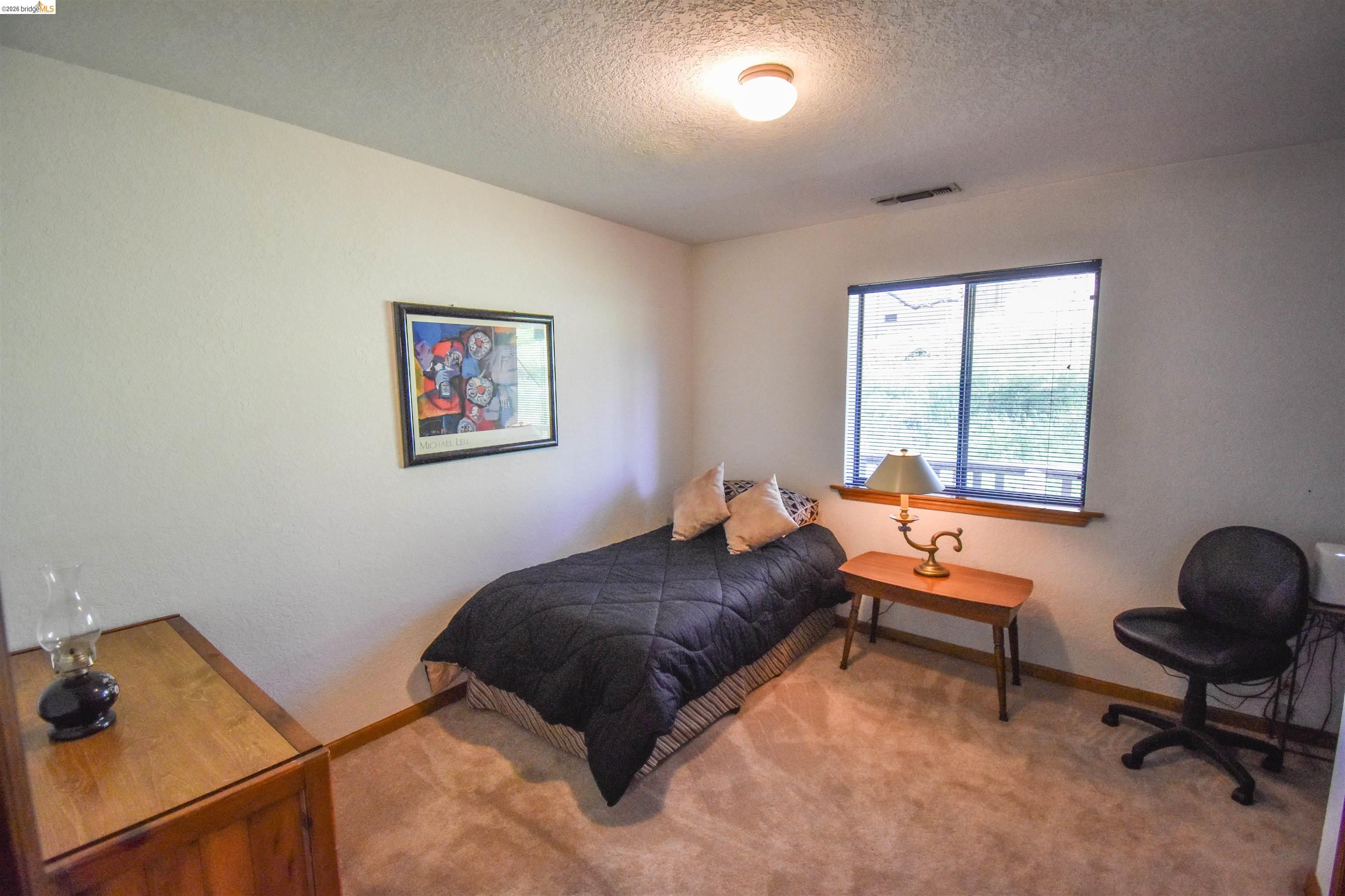 15170 Potato Ranch Road Sonora, CA 95370 - Photo 24 of 49 Bedroom with carpet flooring and a textured ceiling