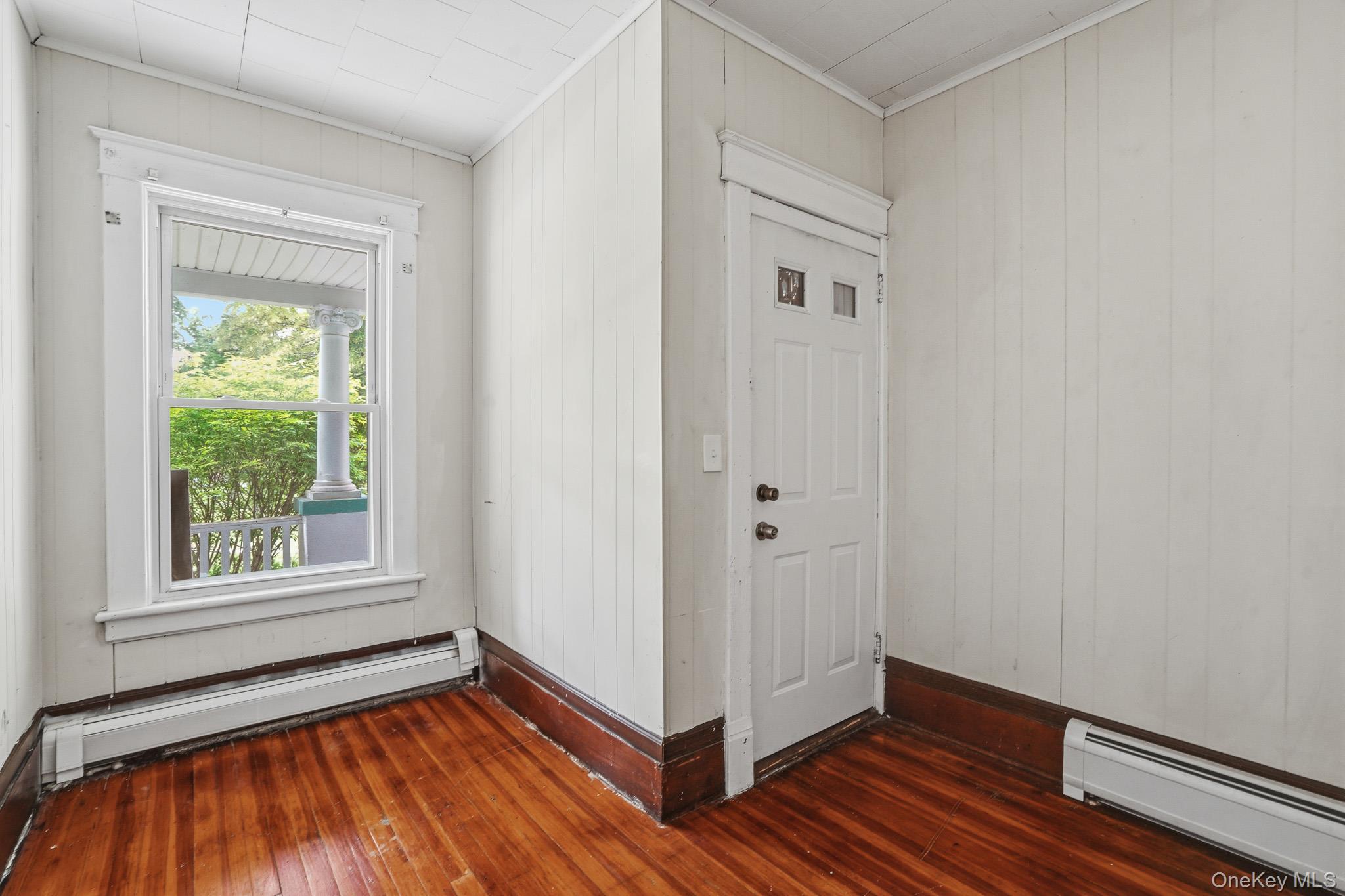 65 North Clinton Street Poughkeepsie, NY 12601 - Photo 7 of 43 a view of an empty room with wooden floor and a window
