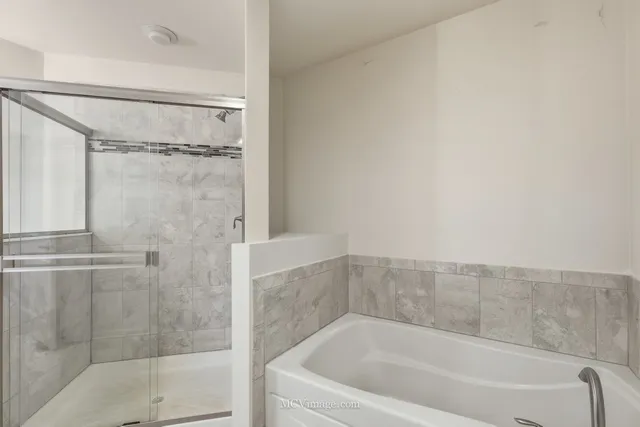 a bathroom with a bathtub and shower