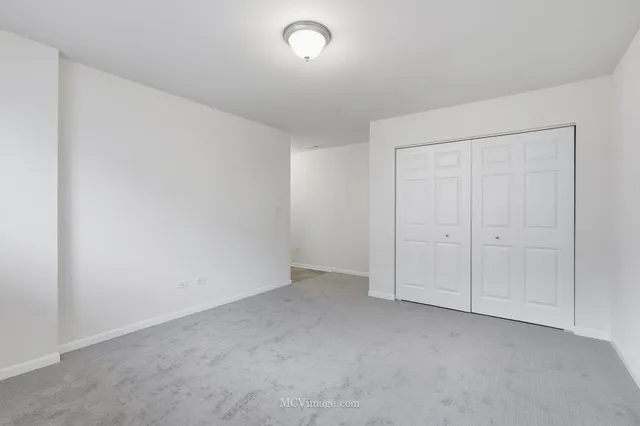 an empty room with closet area