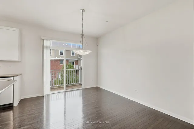 a view of a room with wooden floor and windows