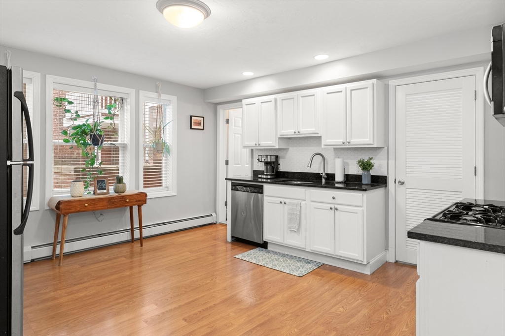39 1/2 Harbor Street, Unit 1 Salem, MA 01970 - Photo 11 of 26 a kitchen with stainless steel appliances granite countertop a stove a sink and a refrigerator