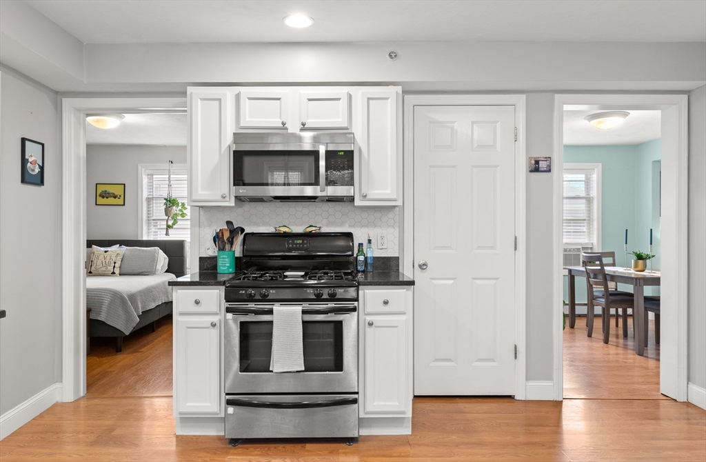 39 1/2 Harbor Street, Unit 1 Salem, MA 01970 - Photo 13 of 26 a kitchen with stainless steel appliances granite countertop a stove and a refrigerator