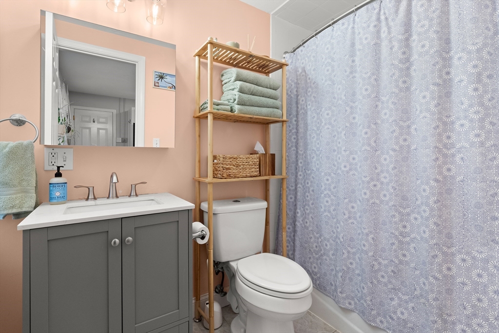 39 1/2 Harbor Street, Unit 1 Salem, MA 01970 - Photo 16 of 26 a bathroom with a granite countertop toilet sink and mirror