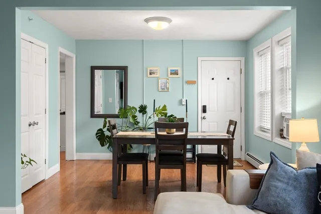a view of a dining room with furniture window and wooden floor