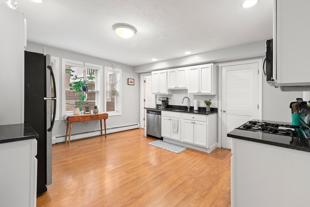 39 1/2 Harbor Street, Unit 1 Salem, MA 01970 - Photo 9 of 26 a kitchen with white cabinets and appliances