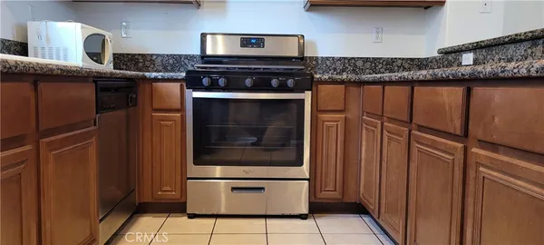 a kitchen with granite countertop a sink and cabinets