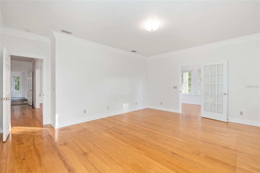 6581 South Magnolia Avenue Ocala, FL 34471 - Photo 12 of 59 wooden floor in an empty room with a window