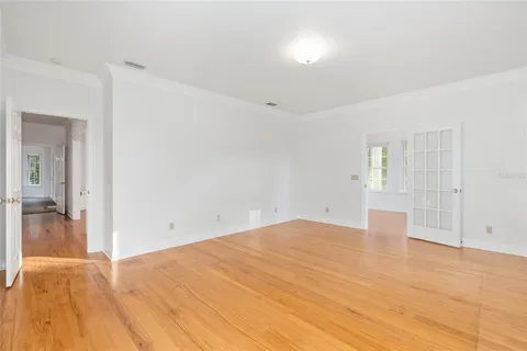 a dining room with furniture potted plants and wooden floor