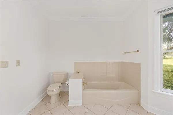 a spacious bathroom with a shower a mirror and a sink