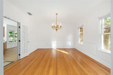 a view of empty room with wooden floor