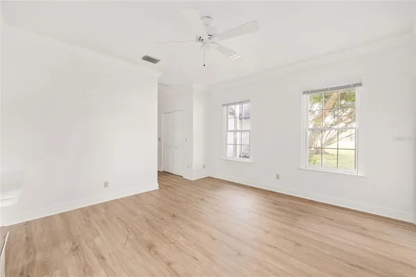 a view of staircase with wooden floor and white walls
