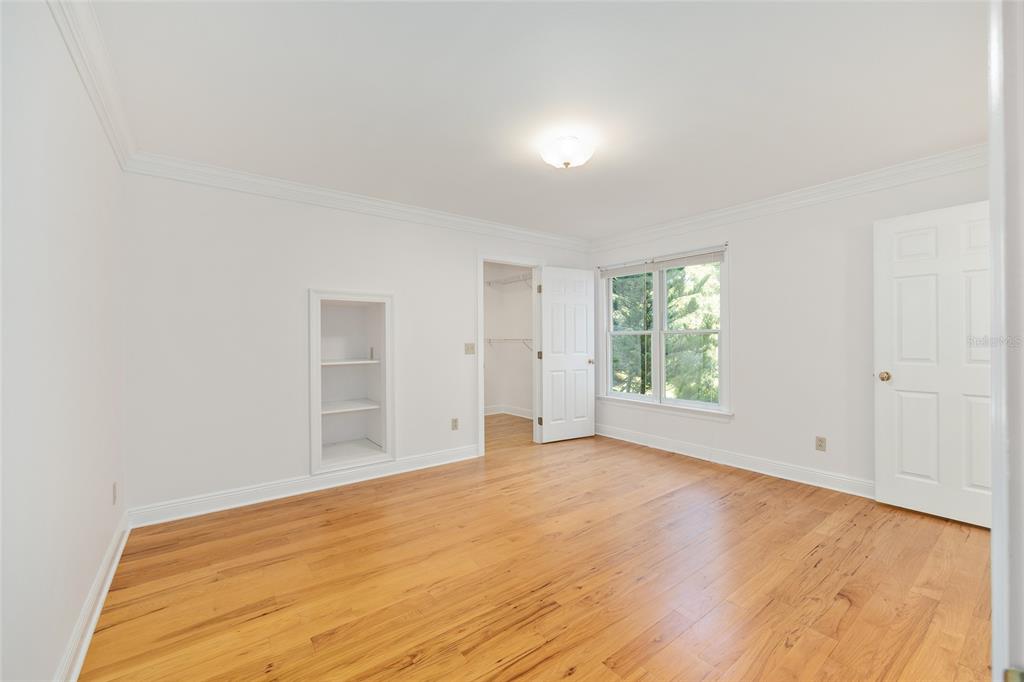 6581 South Magnolia Avenue Ocala, FL 34471 - Photo 37 of 59 an empty room with wooden floor and windows