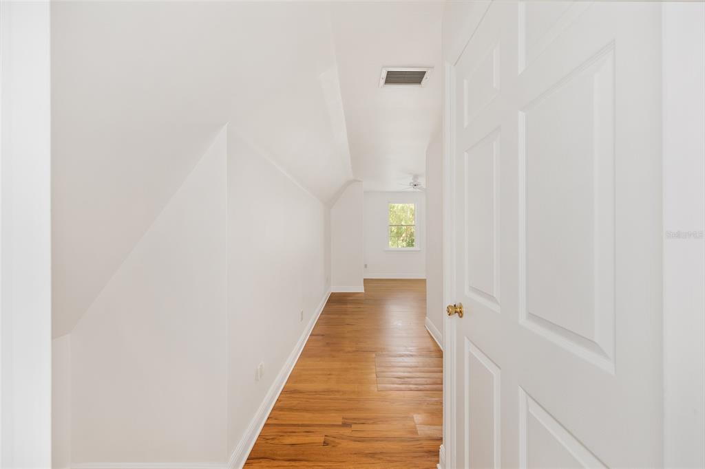 6581 South Magnolia Avenue Ocala, FL 34471 - Photo 42 of 59 a view of a hallway with wooden floor and a bathroom