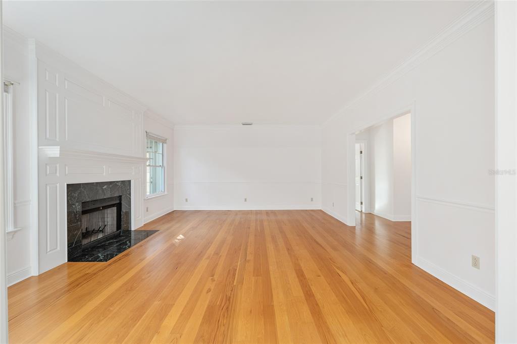 6581 South Magnolia Avenue Ocala, FL 34471 - Photo 6 of 59 a view of empty room with wooden floor and fireplace