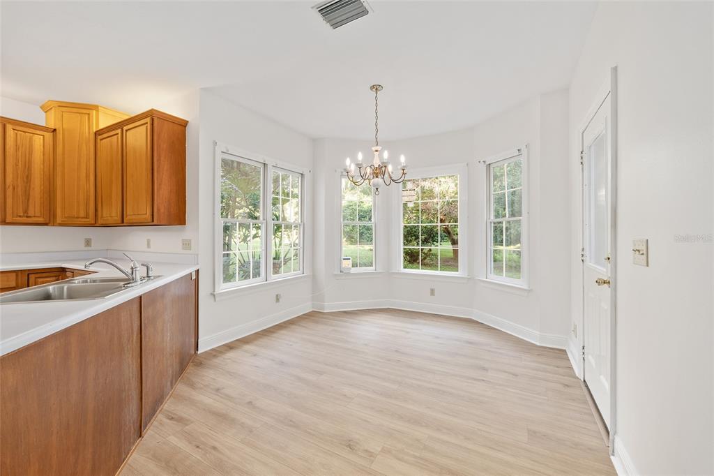 6581 South Magnolia Avenue Ocala, FL 34471 - Photo 9 of 59 a view of a kitchen with a sink dishwasher and wooden floor