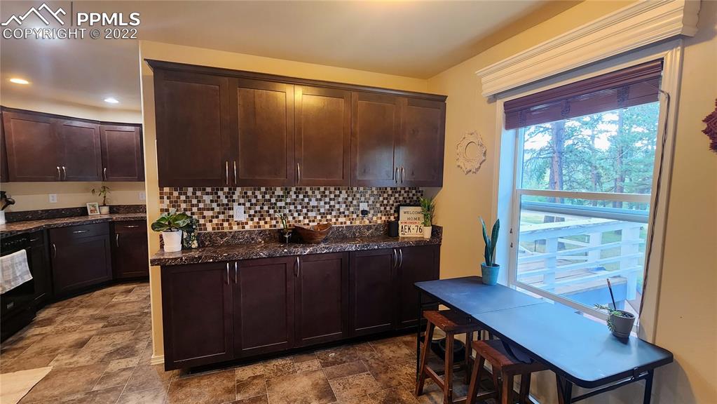 27650 Triple B Road Woodland Park, CO 80863 - Photo 4 of 18 a view of a dining room with furniture and window