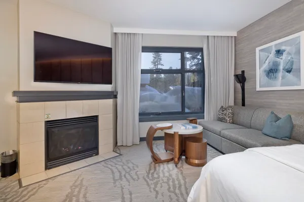 a living room with furniture a flat screen tv and a fireplace