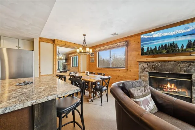 a kitchen with kitchen island granite countertop a stove sink and refrigerator