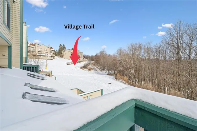 a living room with furniture a flat screen tv and a floor to ceiling window