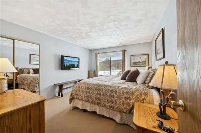 a bathroom with a toilet and a mirror